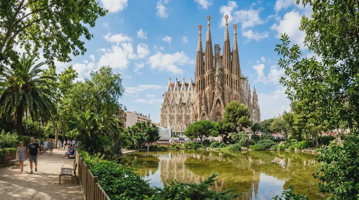 The Sagrada Familia in Barcelona seen across a park pond on a sunny day